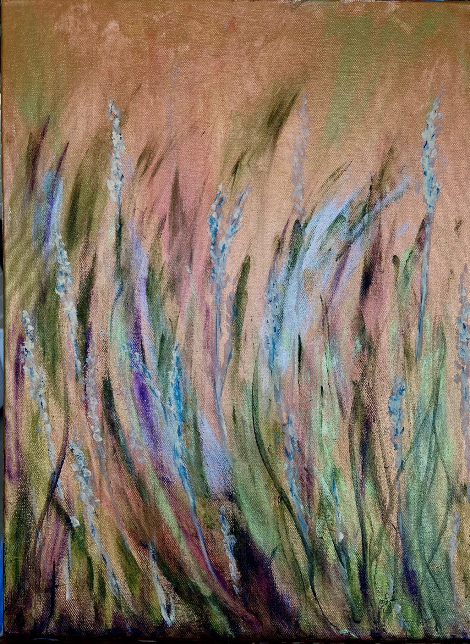 Wheat blowing in wind. Wheat has colors of blues, greens and peach