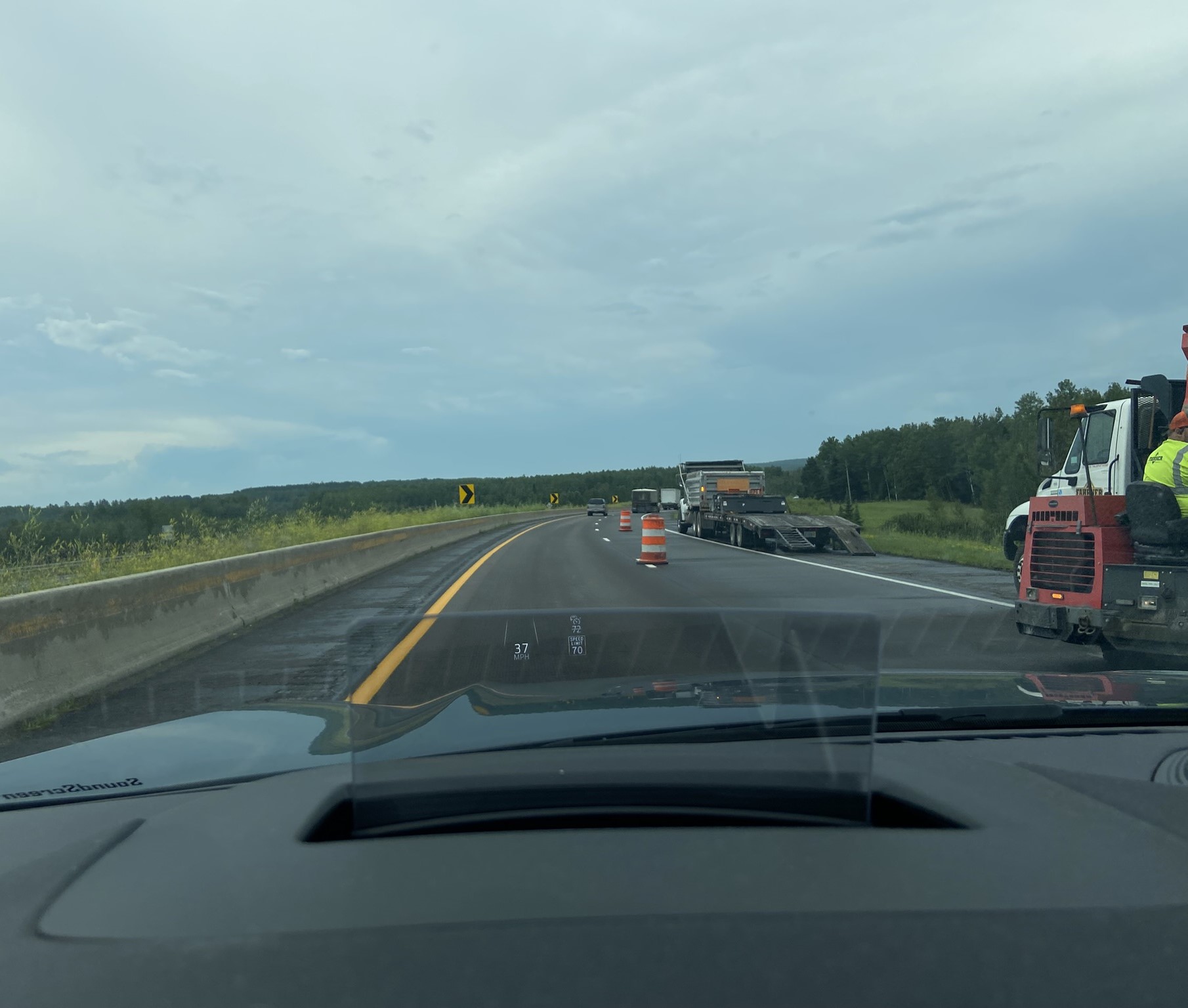 picture out of car front window of highway with construction