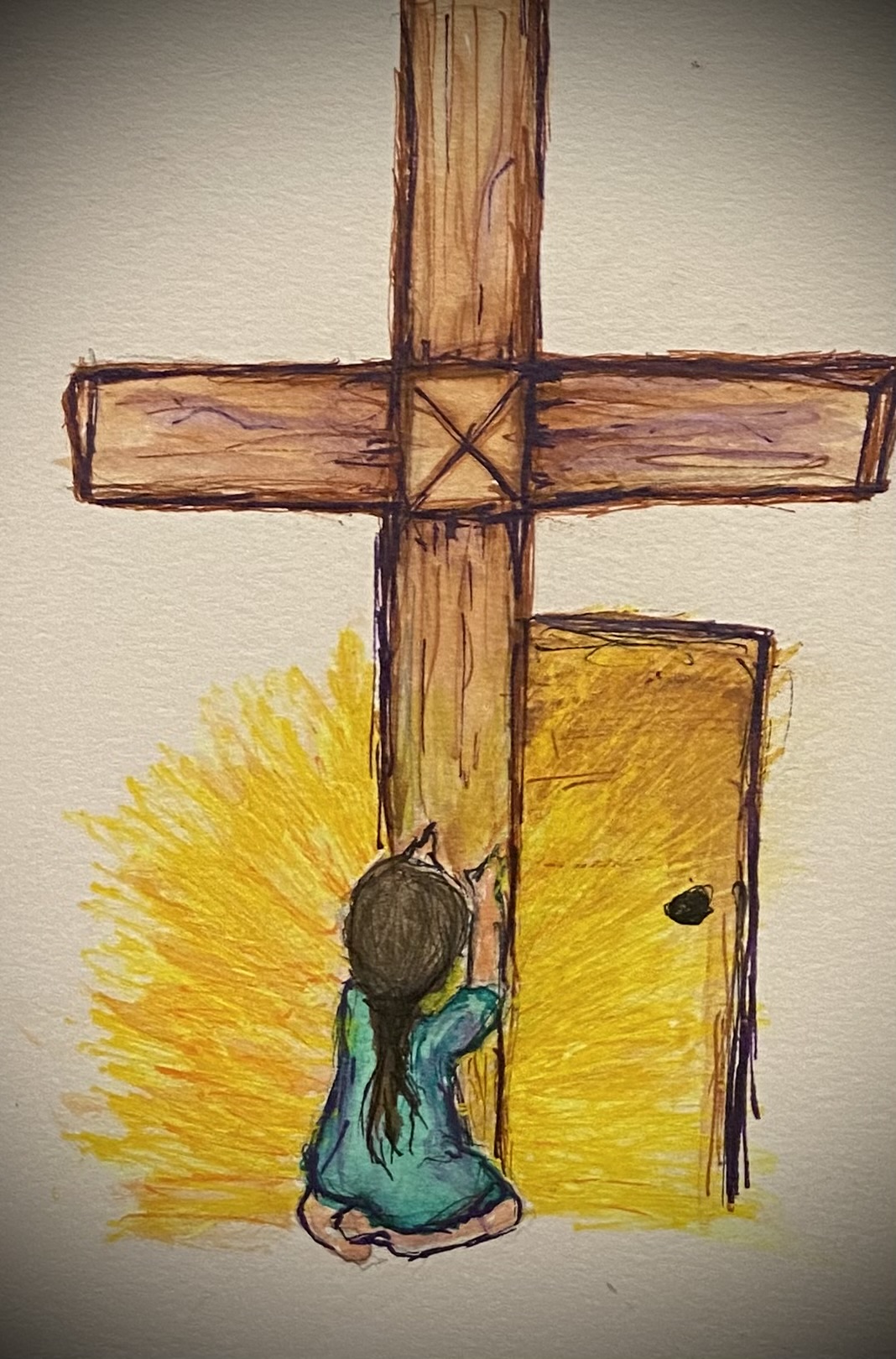girl kneeling at the cross